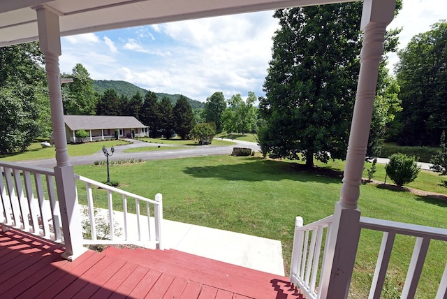 view of yard with a mountain view and covered porch