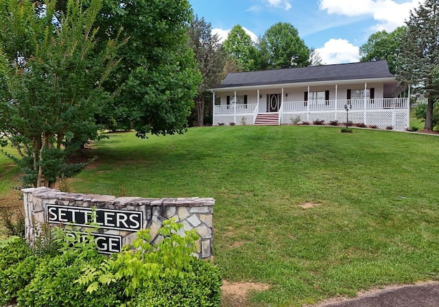 view of front of house with covered porch and a front yard