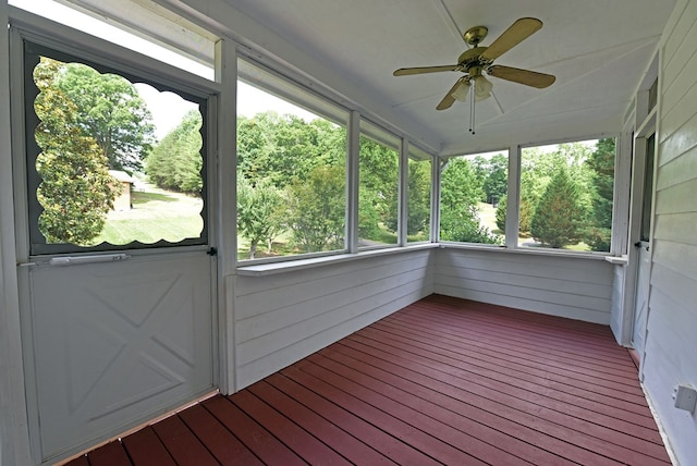 unfurnished sunroom featuring ceiling fan and a healthy amount of sunlight