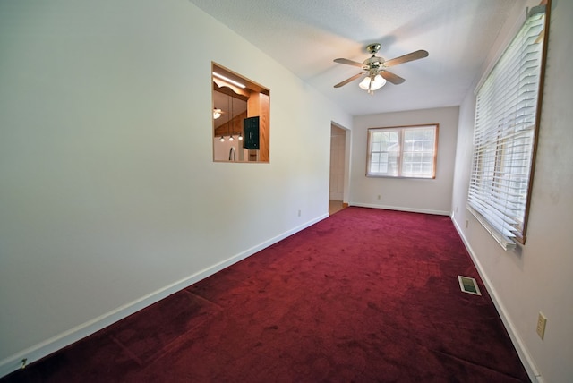 spare room featuring ceiling fan and carpet floors