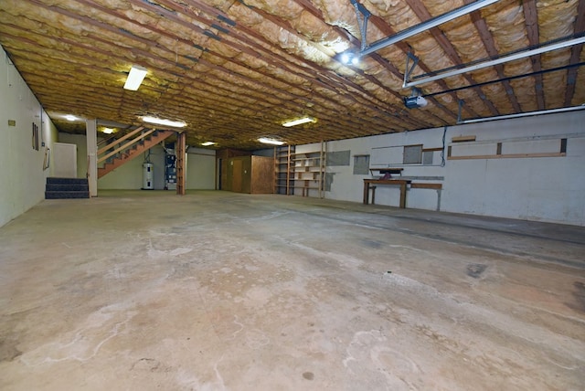 garage featuring a garage door opener and water heater