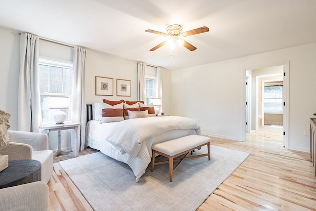 bedroom featuring multiple windows, light hardwood / wood-style floors, and ceiling fan