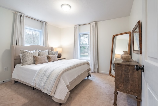 bedroom featuring light carpet