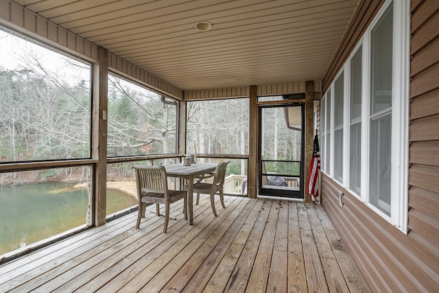 unfurnished sunroom with a water view and wood ceiling