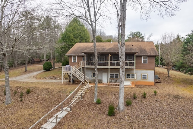 rear view of house featuring a deck