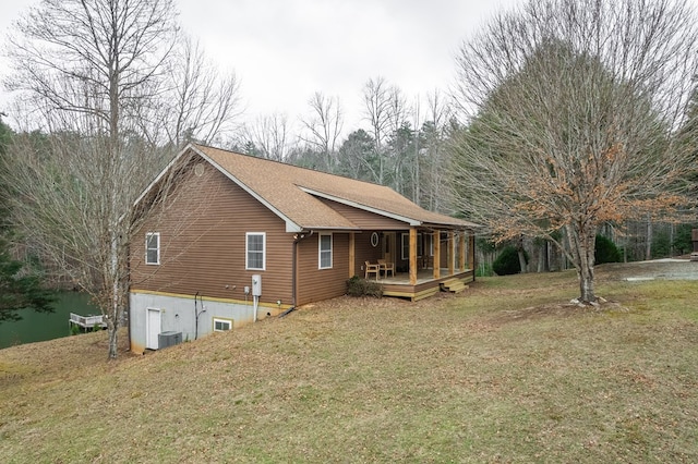 view of home's exterior with a deck, a lawn, and central air condition unit