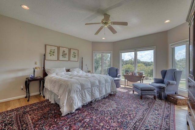 bedroom featuring a textured ceiling, ceiling fan, and light hardwood / wood-style flooring