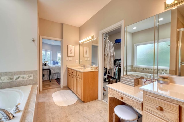 bathroom with vanity, tile patterned flooring, and separate shower and tub