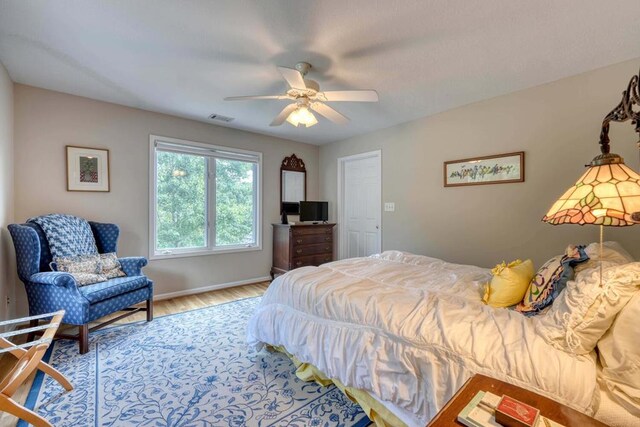 bedroom featuring hardwood / wood-style floors and ceiling fan