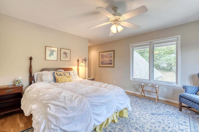 bedroom with light hardwood / wood-style floors and ceiling fan