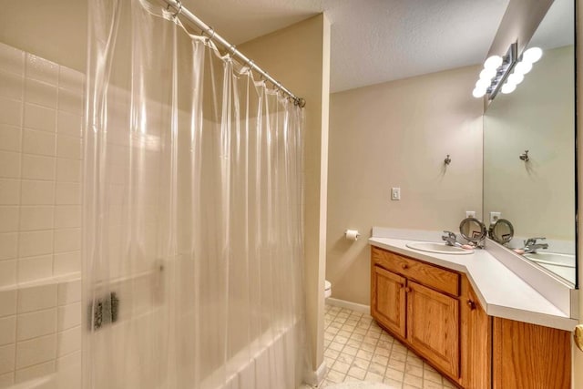 bathroom featuring vanity, toilet, and a textured ceiling