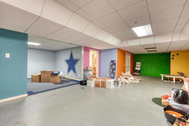 basement with a paneled ceiling