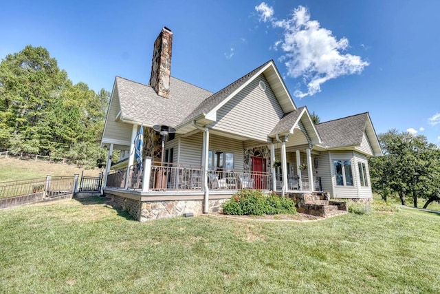 view of front of house with covered porch and a front yard