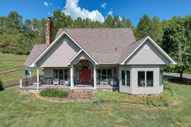 view of front of home with covered porch and a front yard