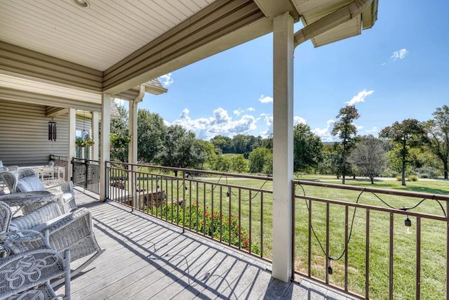 wooden deck featuring a lawn