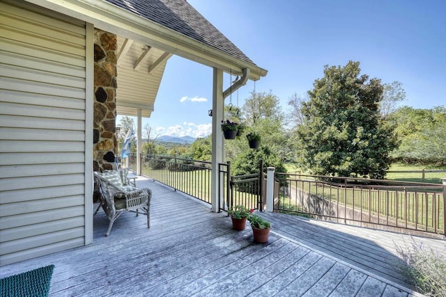 wooden deck with a mountain view