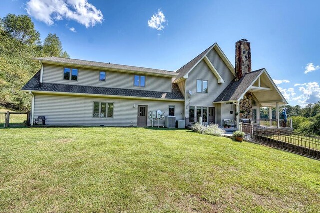 back of house with a yard, a patio, and central AC