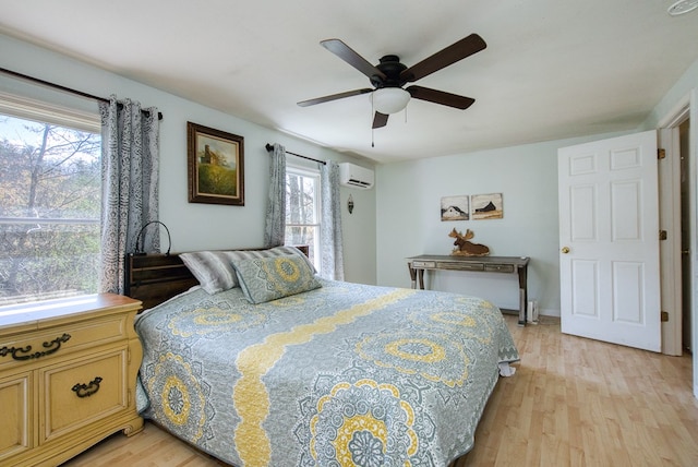 211 Gregory Hollow Rd, Robbinsville, NC 28771 - bedroom with ceiling fan, light wood-type flooring, and a wall unit AC