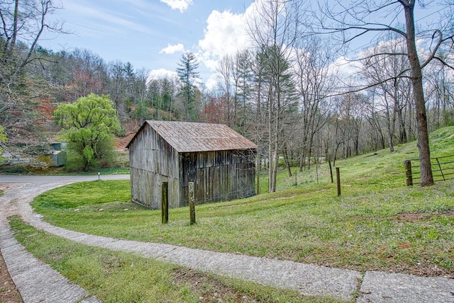 211 Gregory Hollow Rd, Robbinsville, NC 28771 - view of outdoor structure with driveway, a forest view, and an outbuilding