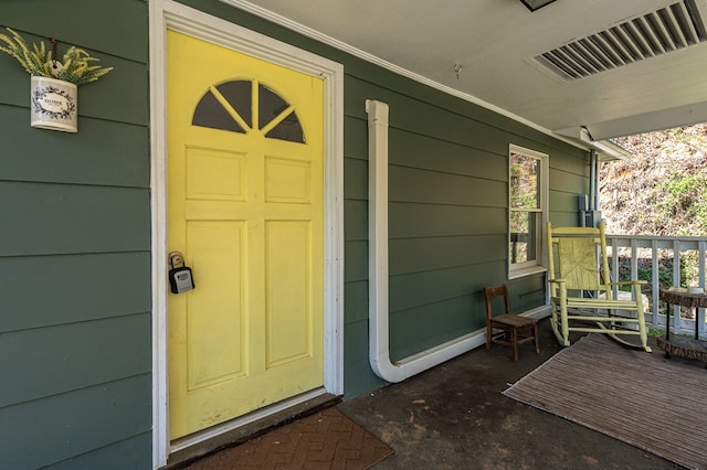 211 Gregory Hollow Rd, Robbinsville, NC 28771 - doorway to property featuring visible vents and covered porch