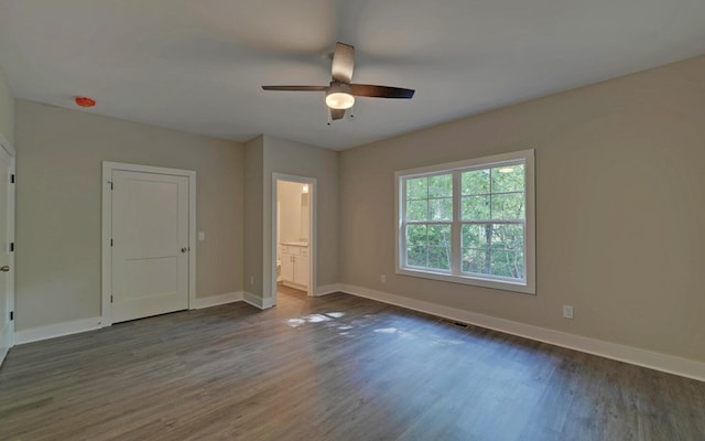 unfurnished bedroom featuring dark hardwood / wood-style floors and ceiling fan