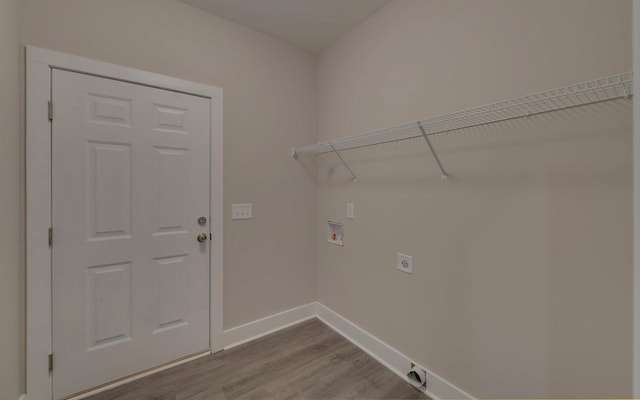 laundry area featuring baseboards, washer hookup, wood finished floors, electric dryer hookup, and laundry area