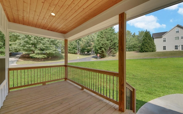 wooden terrace featuring a lawn