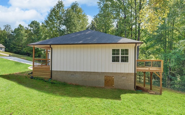 view of home's exterior featuring a shingled roof, crawl space, a lawn, and a wooden deck