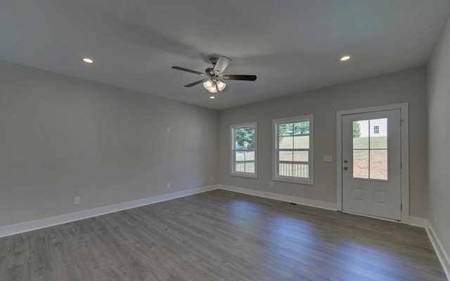 spare room with recessed lighting, dark wood finished floors, a ceiling fan, and baseboards