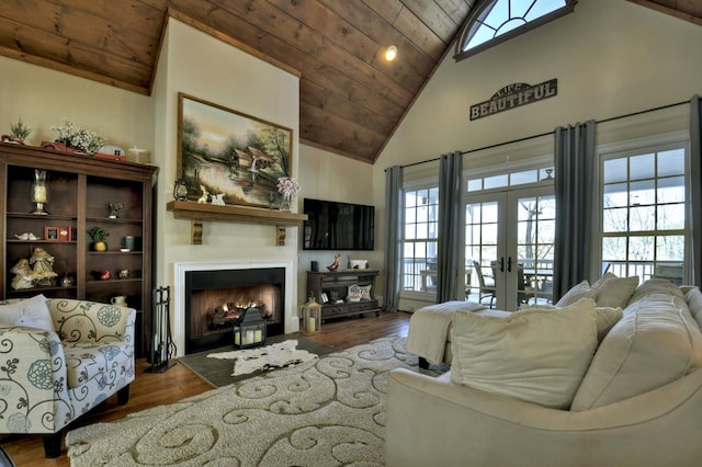 living room featuring wood finished floors, high vaulted ceiling, a fireplace with flush hearth, wood ceiling, and french doors