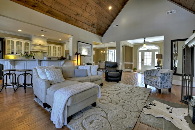 living room featuring visible vents, crown molding, and hardwood / wood-style flooring