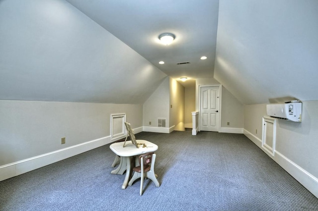 additional living space with visible vents, baseboards, and vaulted ceiling