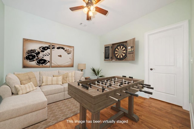 playroom featuring wood finished floors, a ceiling fan, and visible vents