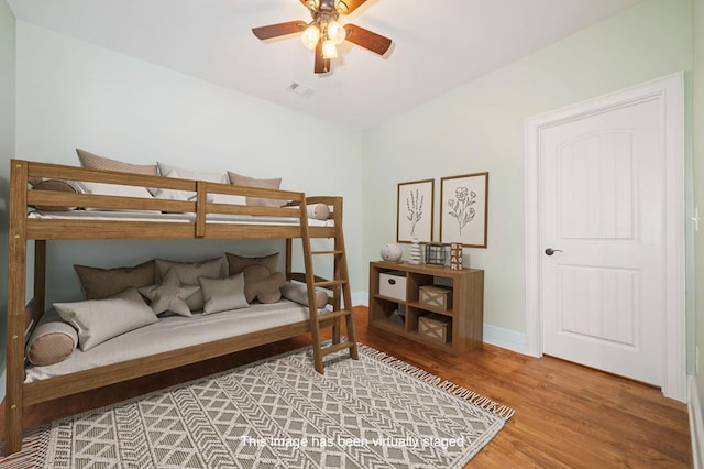 bedroom featuring visible vents, ceiling fan, baseboards, and light wood-style floors