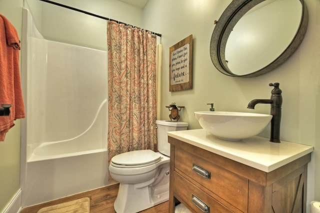 full bath featuring vanity, toilet, wood finished floors, and shower / bath combo with shower curtain