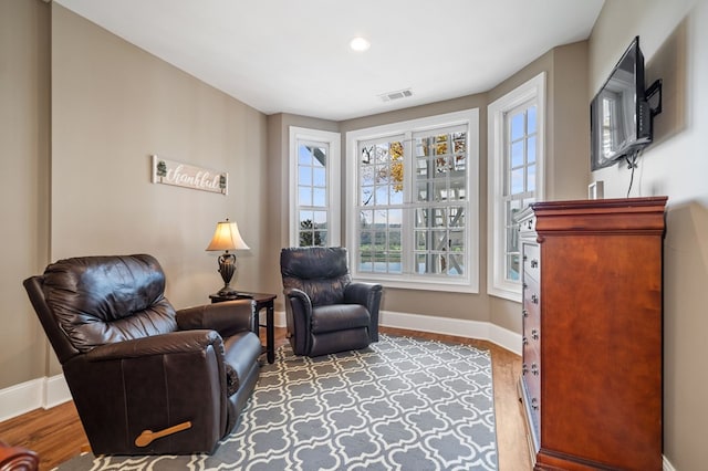 sitting room with recessed lighting, wood finished floors, visible vents, and baseboards