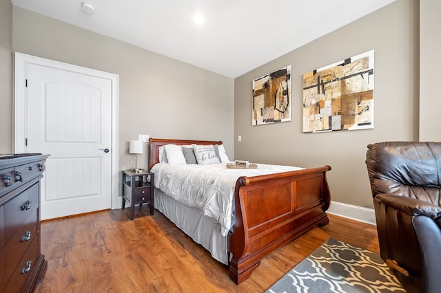 bedroom featuring baseboards and wood finished floors