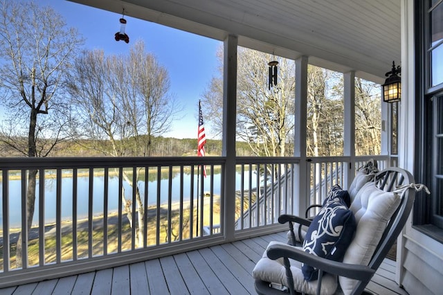 wooden terrace featuring a water view