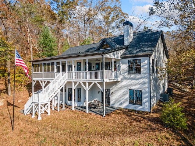 rear view of property with a patio, stairway, a sunroom, ceiling fan, and a chimney