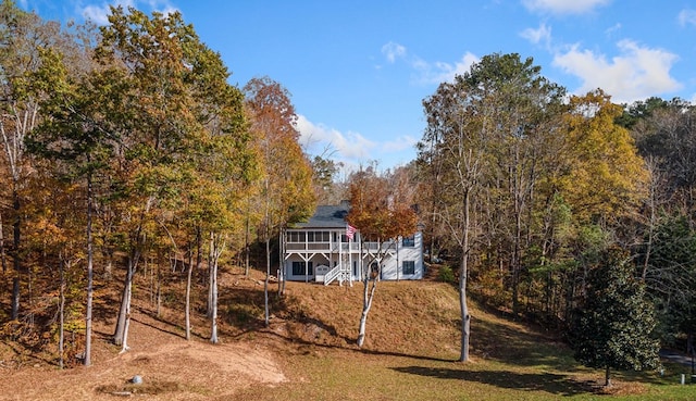 exterior space with a wooden deck and a view of trees