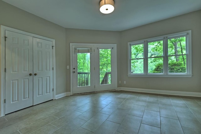 doorway with light tile patterned flooring