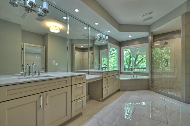 bathroom featuring shower with separate bathtub and vanity