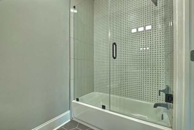 bathroom featuring shower / bath combination with glass door and tile patterned flooring