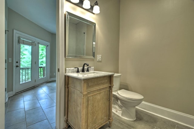 bathroom featuring toilet, vanity, and tile patterned floors