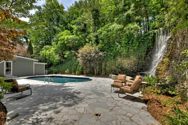 view of swimming pool featuring a patio area