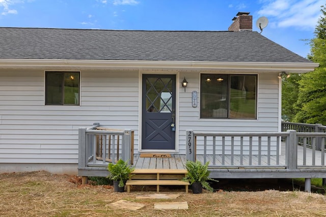 2793 Hidden Valley Rd, Hiawassee, GA 30546 - view of exterior entry featuring a chimney, roof with shingles, and a wooden deck