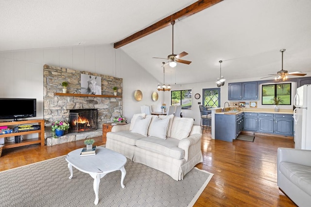 2793 Hidden Valley Rd, Hiawassee, GA 30546 - living room with a ceiling fan, wood finished floors, a stone fireplace, and wood walls