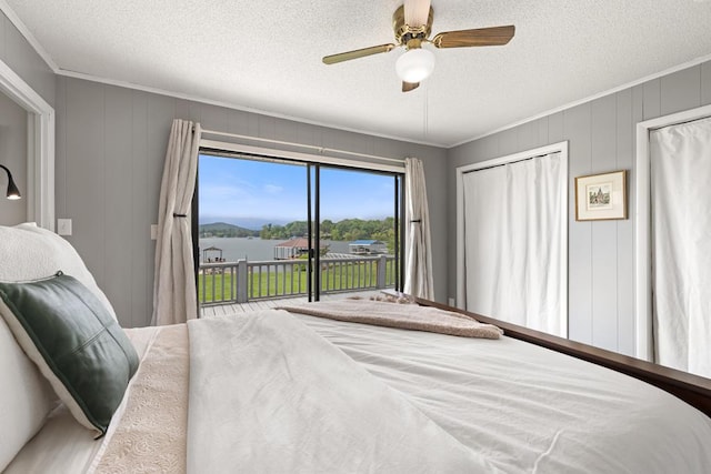 2793 Hidden Valley Rd, Hiawassee, GA 30546 - bedroom featuring access to exterior, a textured ceiling, ornamental molding, a water view, and a ceiling fan