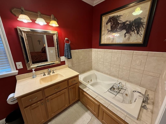 bathroom with a tub to relax in, vanity, and ornamental molding