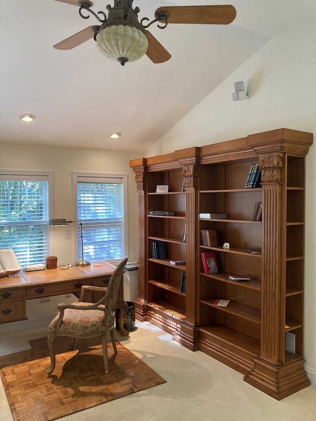 office space with lofted ceiling, ceiling fan, and carpet flooring